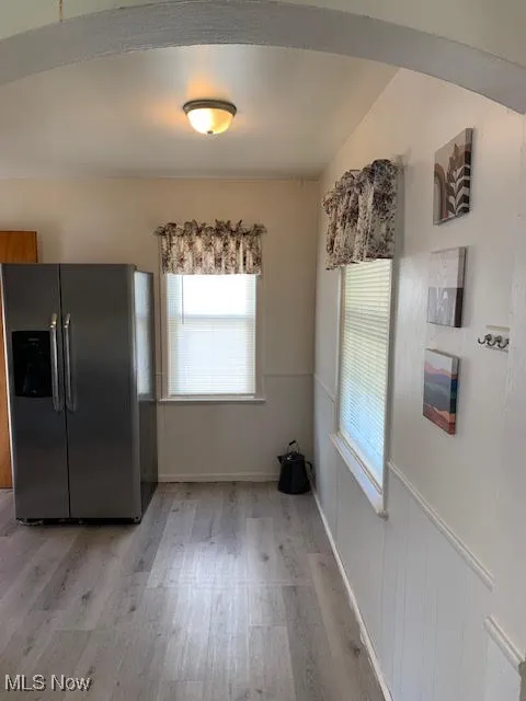 Unfurnished dining area featuring light wood-style flooring and plenty of natural light