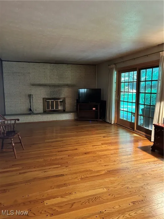 Unfurnished living room featuring hardwood / wood-style flooring