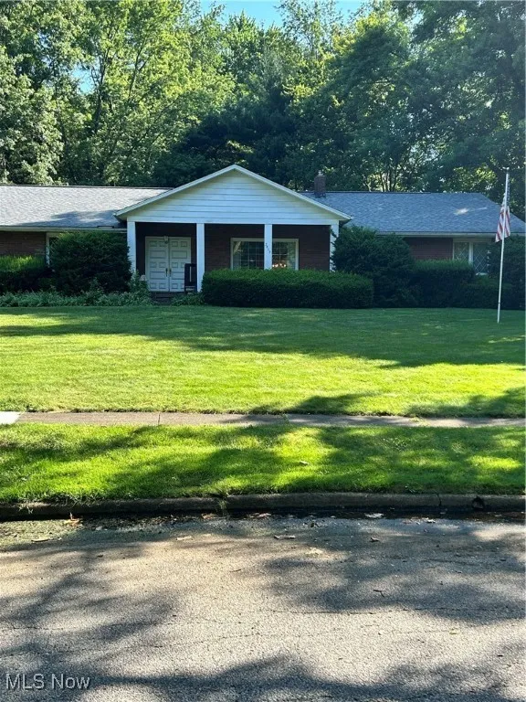 View of front of house featuring a front lawn and a chimney