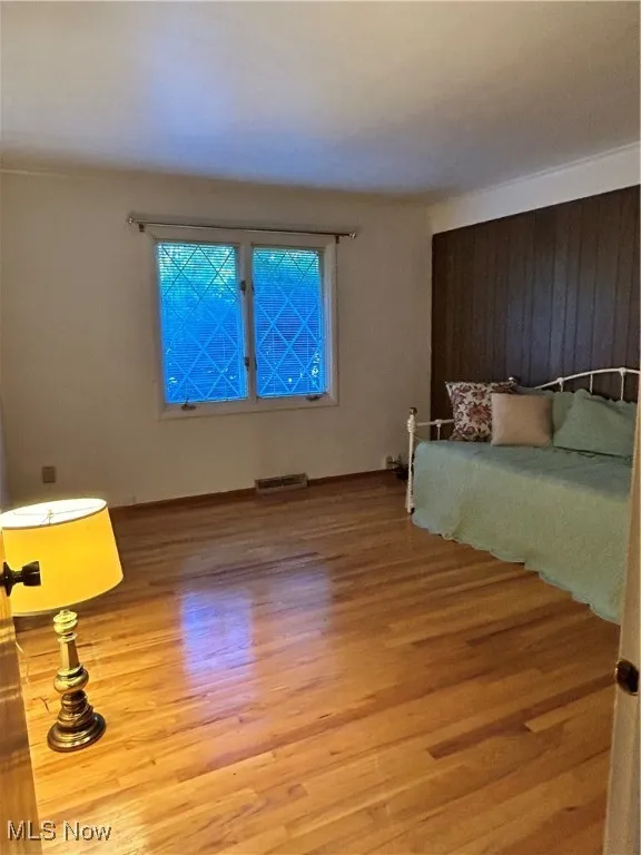 Unfurnished bedroom featuring wood finished floors