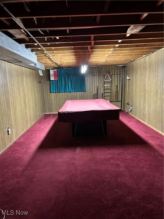 Game room featuring pool table, wood walls, and carpet