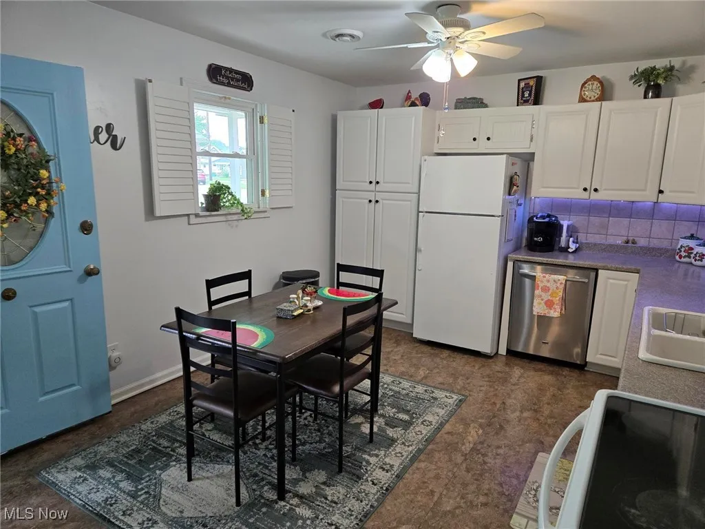 Dining area featuring ceiling fan and baseboards