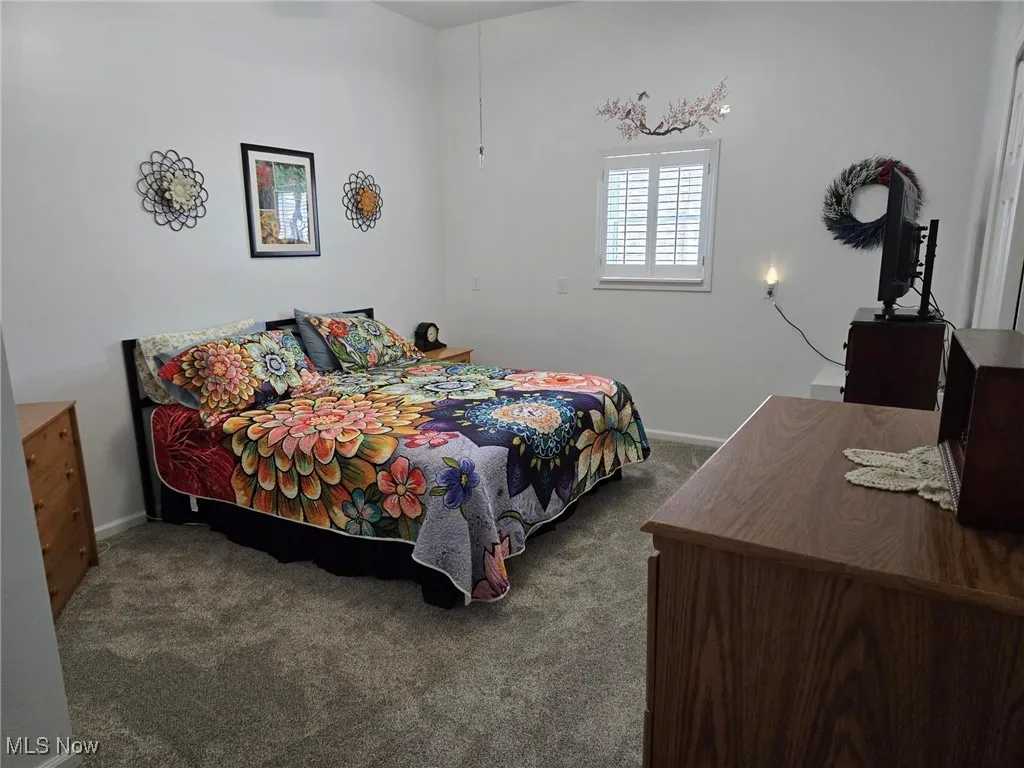 Carpeted bedroom with baseboards
