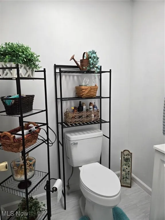 Half bath with wood finished floors