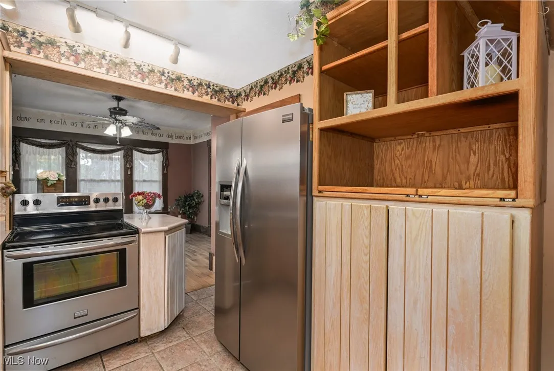 Kitchen featuring appliances with stainless steel finishes, a ceiling fan, and rail lighting