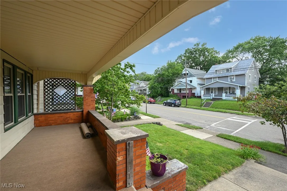 Porch featuring a yard and a residential view