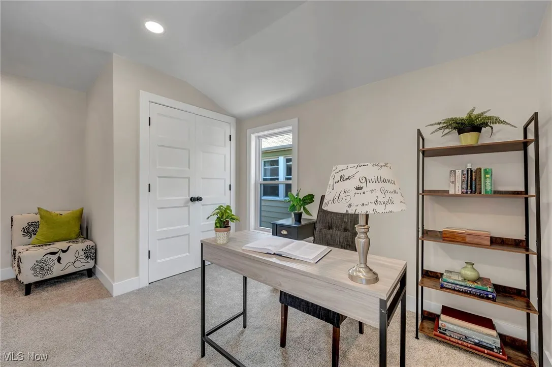 Office space featuring lofted ceiling, carpet flooring, and recessed lighting