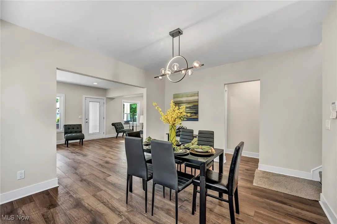 Dining room featuring dark wood-type flooring and a chandelier