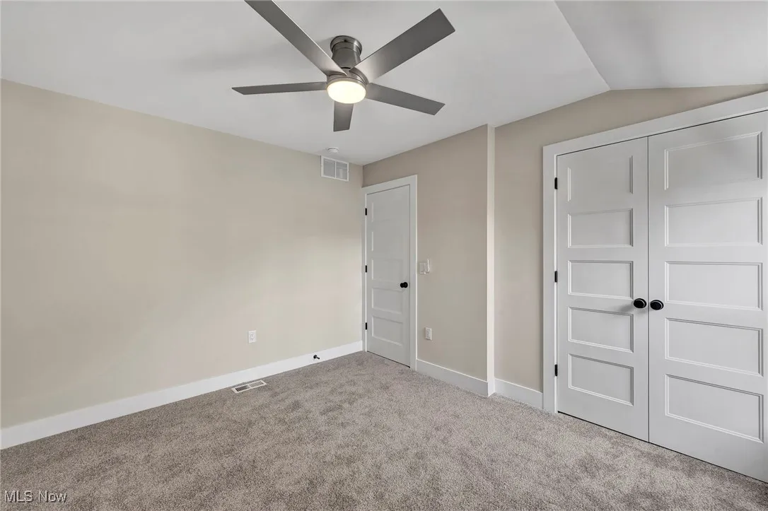 Unfurnished bedroom featuring carpet, a closet, and ceiling fan