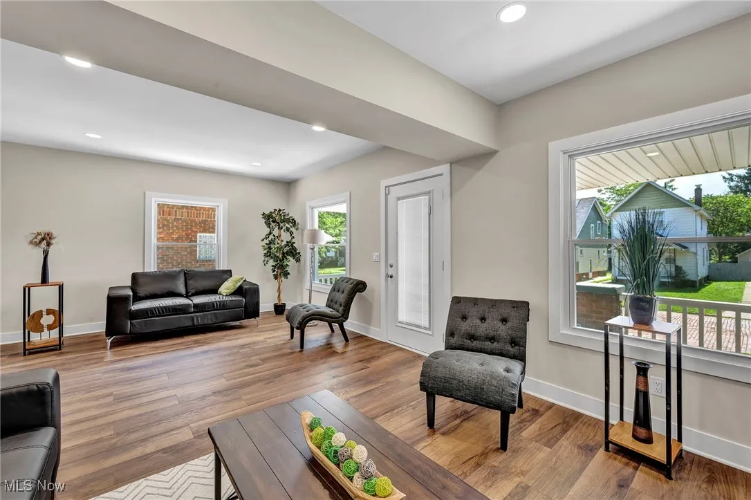 Living area with wood finished floors and recessed lighting