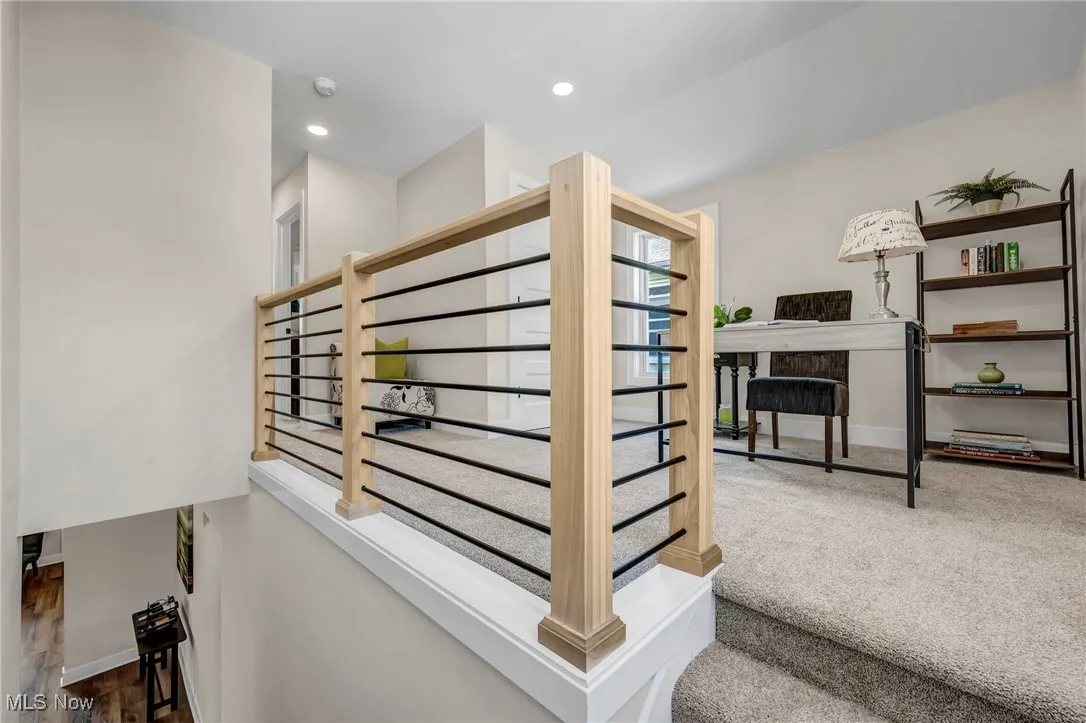 Staircase with baseboards and recessed lighting