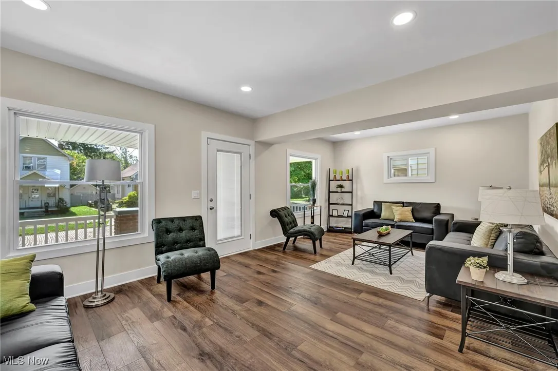 Living room featuring dark wood finished floors and recessed lighting