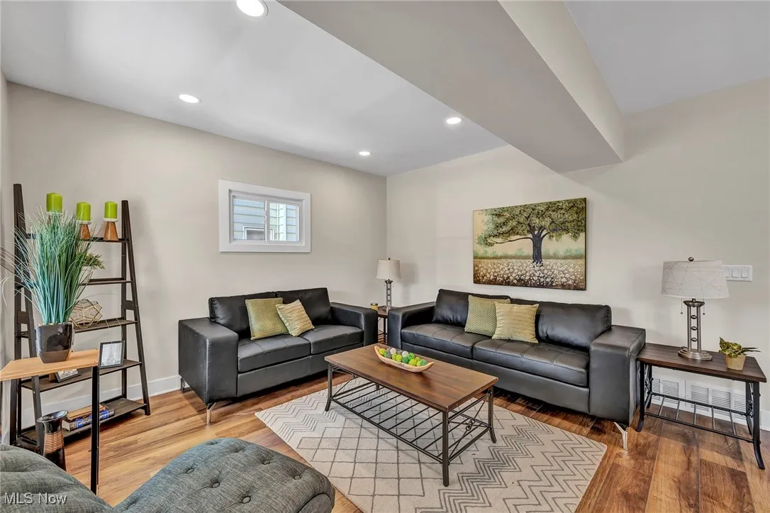 Living room featuring wood finished floors and recessed lighting