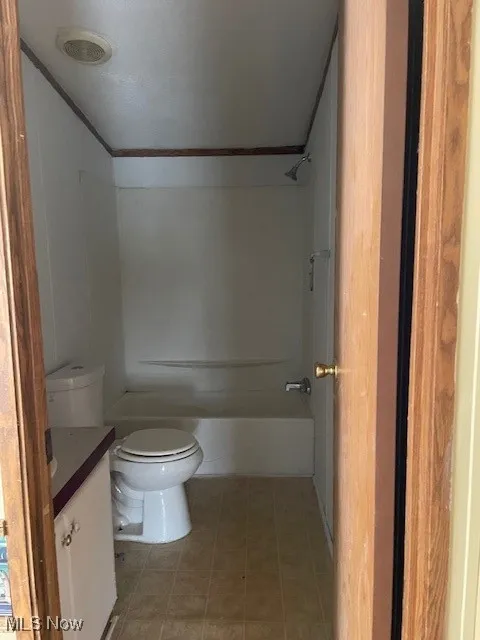 Bathroom featuring vanity, shower / washtub combination, and ornamental molding