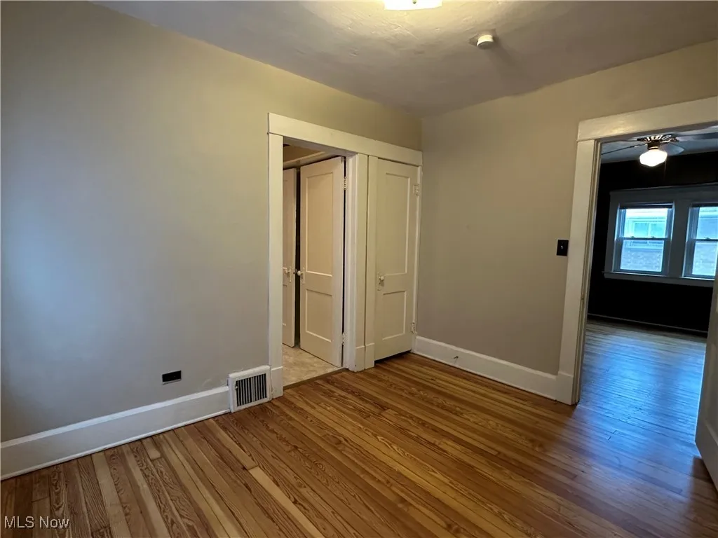 Unfurnished bedroom featuring wood finished floors and a closet