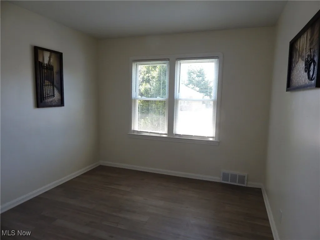 Freshly updated Bedroom 2. New flooring, blinds, light fixture and updated windows.