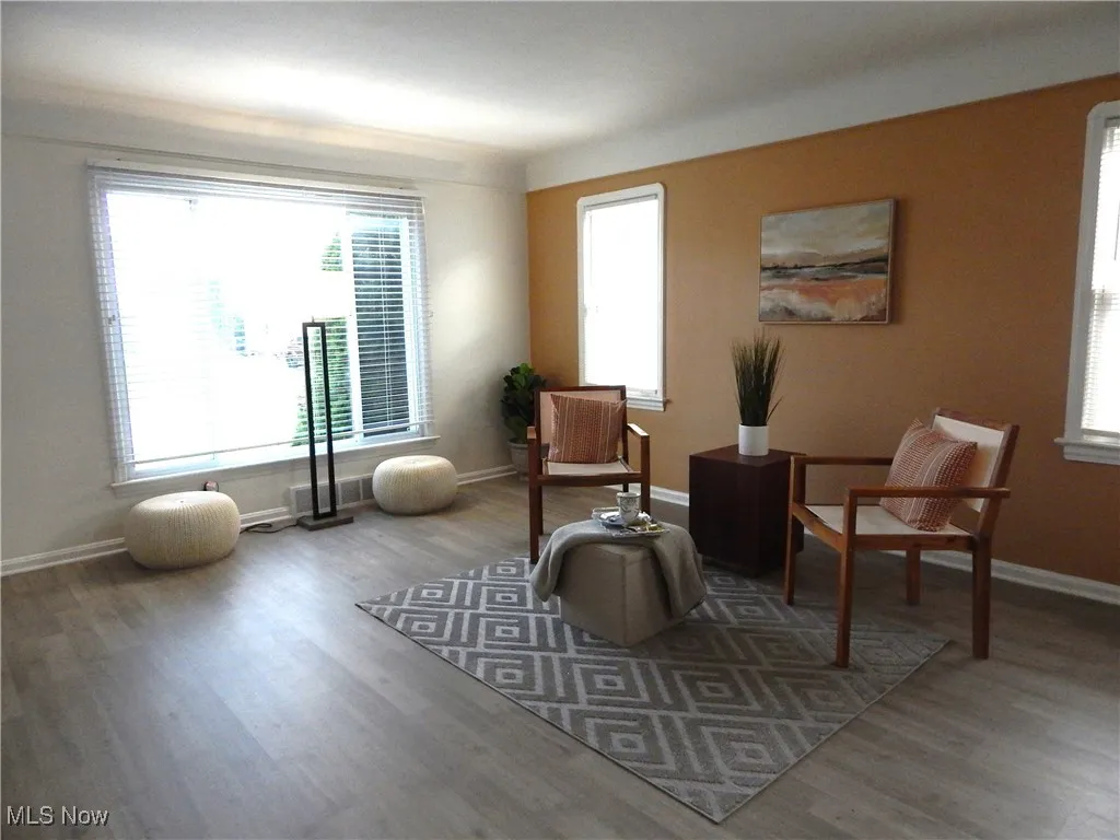 Living area with updated picture window & Plantation Blinds, lets in lots of natural light. new LVT Flooring and painted with the latest color paillette.