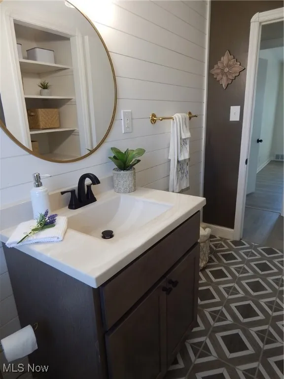 Bathroom with new vanity, toilet, fixtures, lighting and shiplap wood walls.