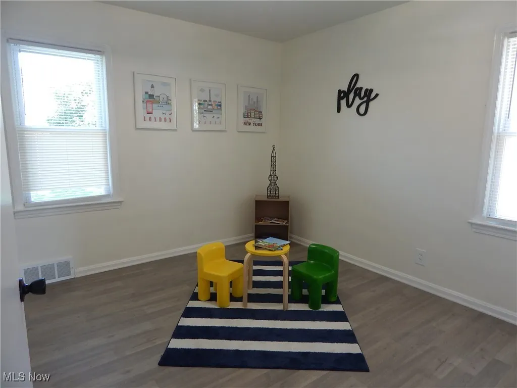 Updated bedroom 3 is a great size with 2 windows, new LVT floors, light fixture with fresh paint.