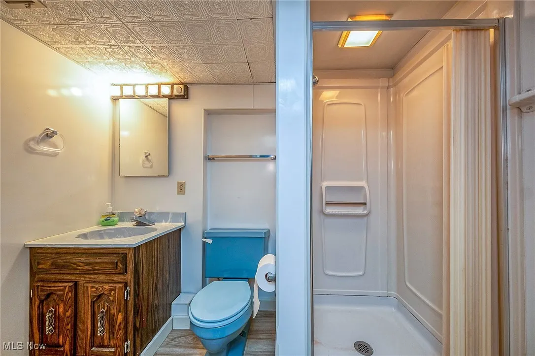 Full bath featuring vanity and a shower