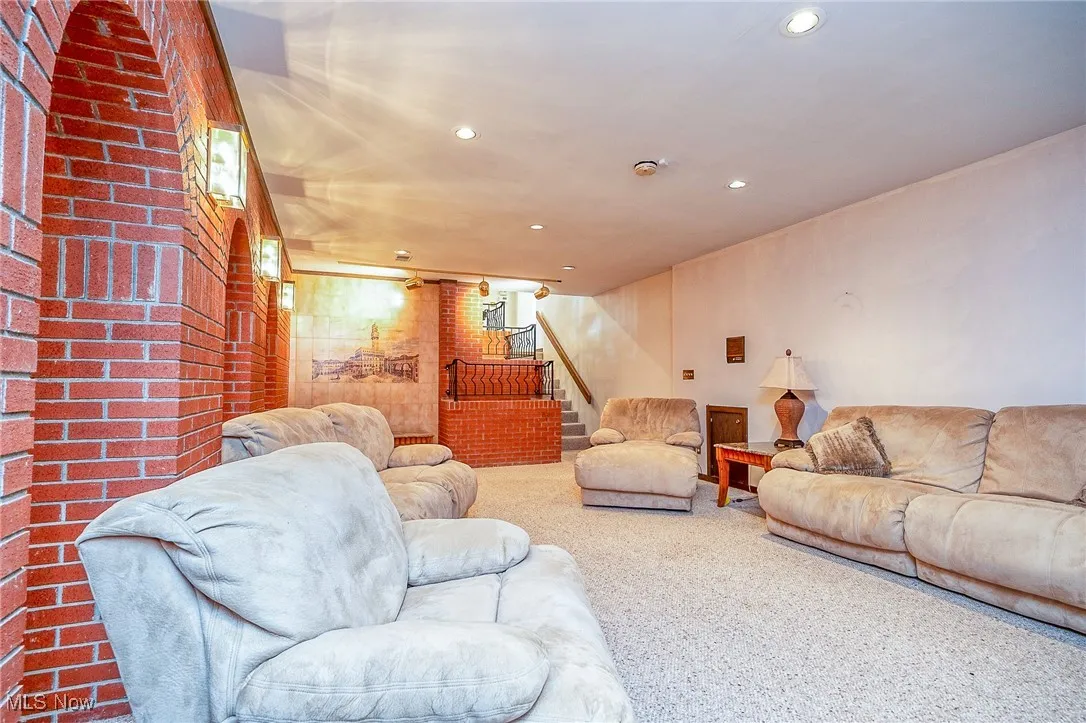 Living area featuring stairs, recessed lighting, and carpet flooring