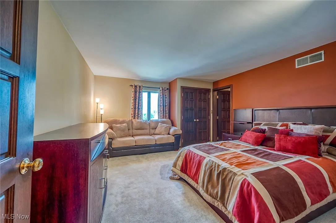 Bedroom featuring light colored carpet