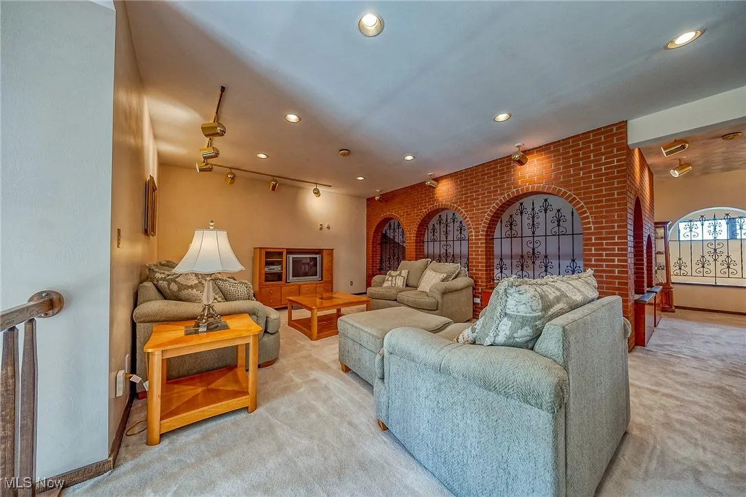 Living area featuring light carpet and recessed lighting
