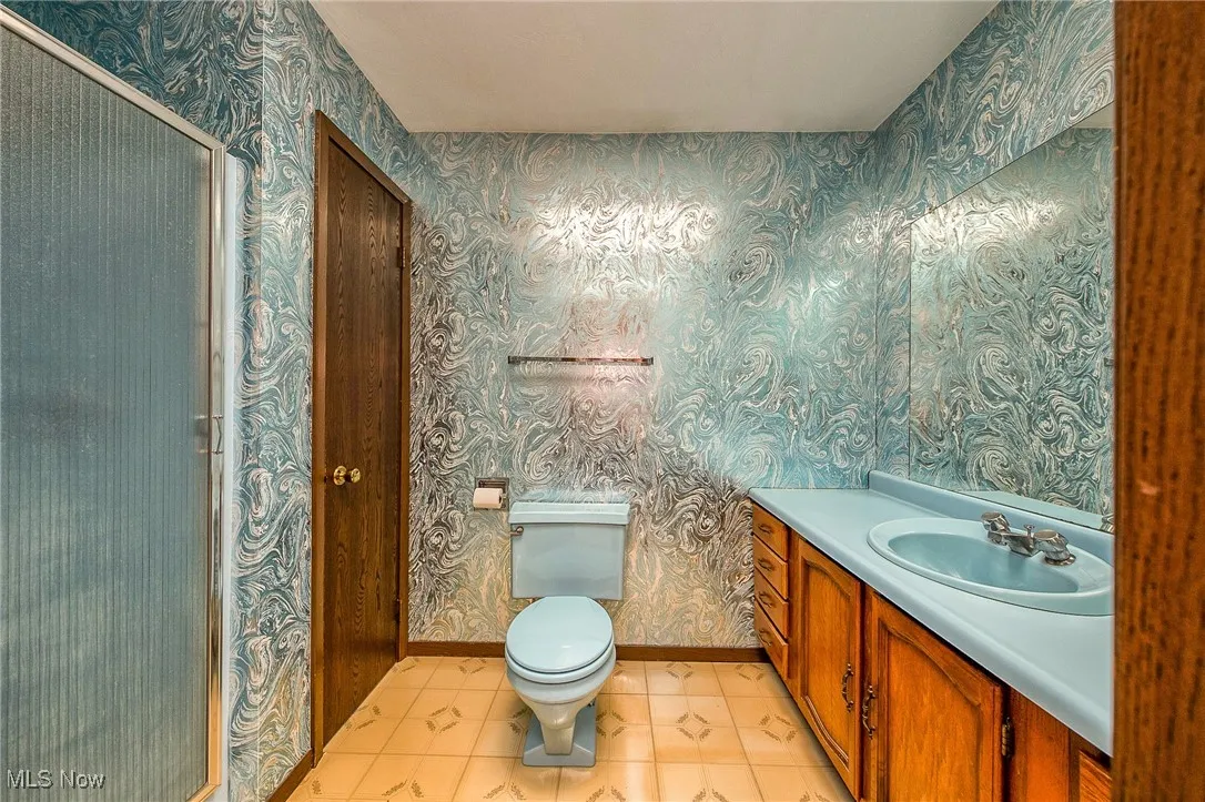 Bathroom featuring vanity, a stall shower, and tile patterned floors