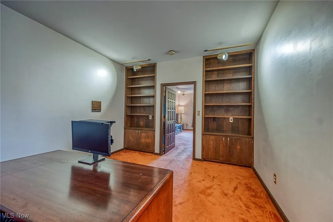 Office area with built in features and light carpet