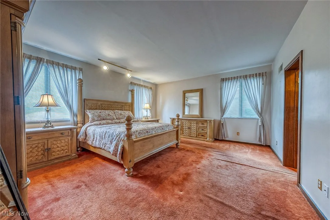 Bedroom featuring light colored carpet