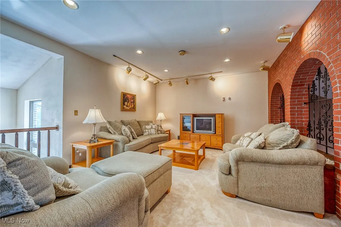 Living room with light colored carpet and recessed lighting