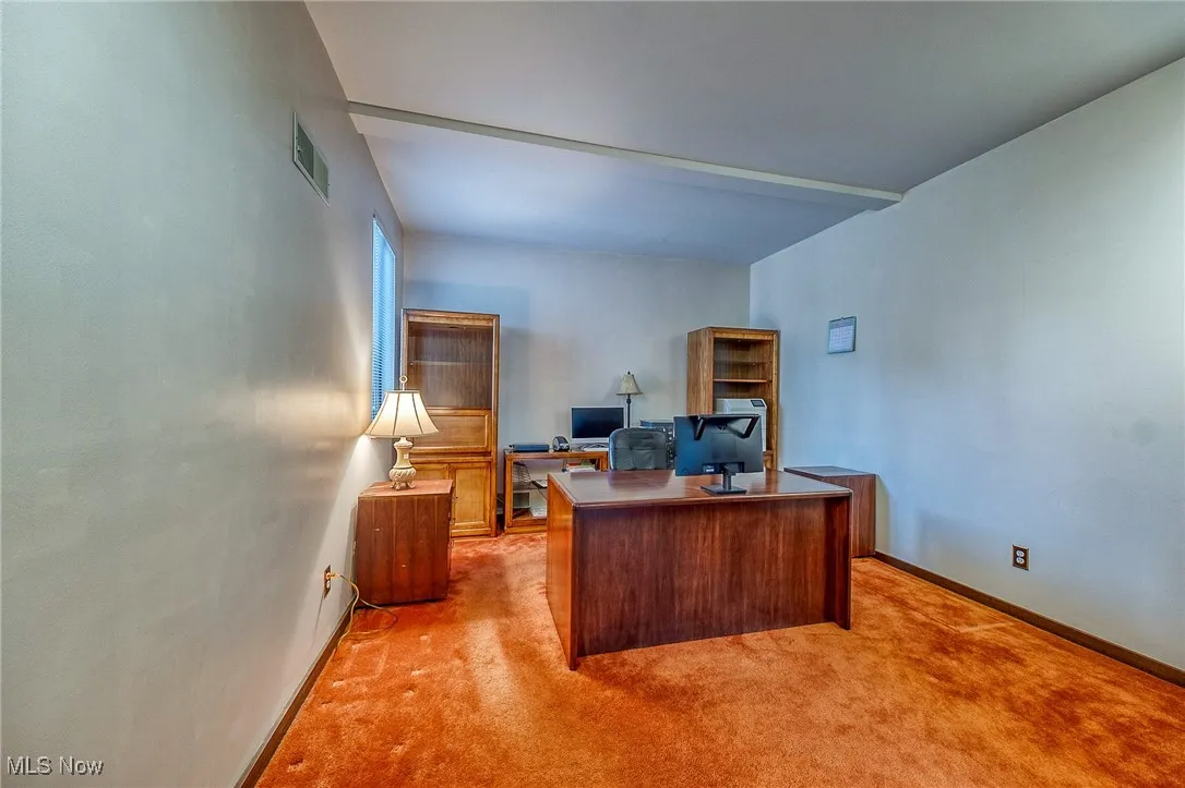 Office space with carpet and baseboards