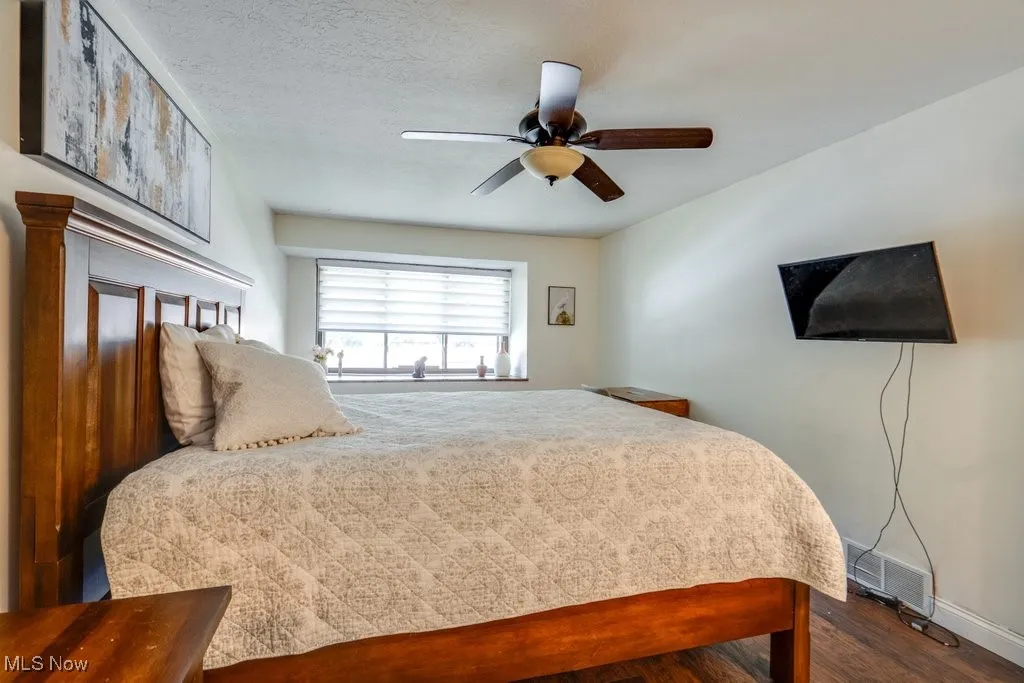 Bedroom with wood finished floors and ceiling fan