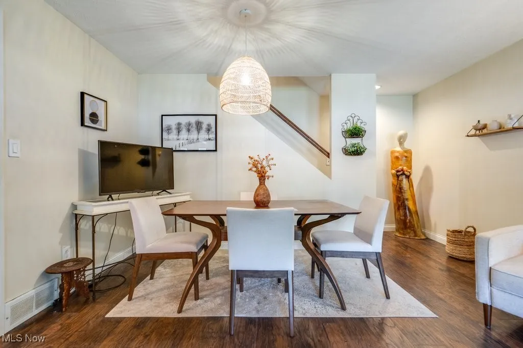 Dining area with wood finished floors and stairs