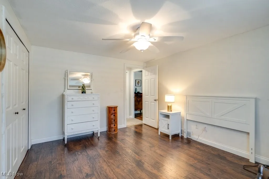 Bedroom with wood finished floors, a closet, and ceiling fan
