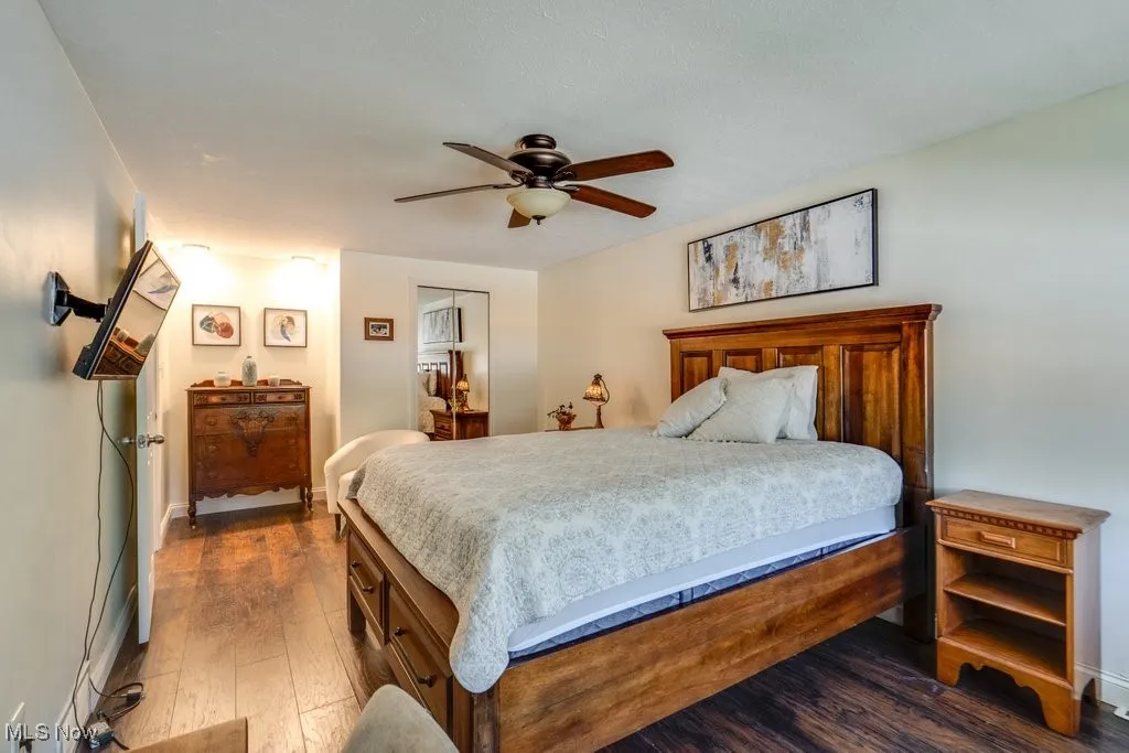 Bedroom featuring dark wood-style floors and a ceiling fan