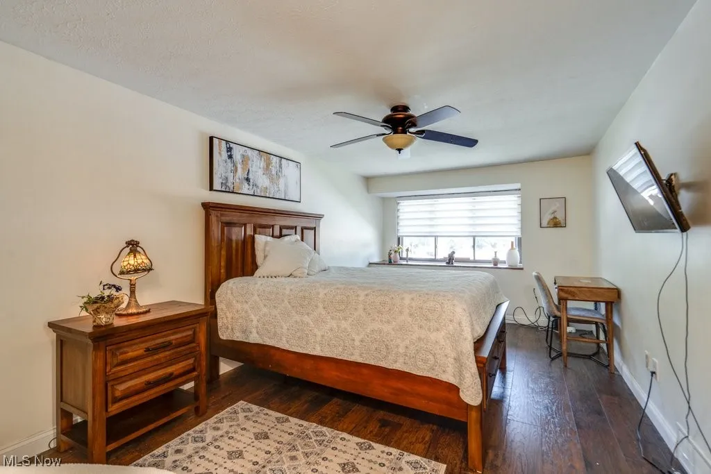 Bedroom featuring dark wood-style floors and ceiling fan