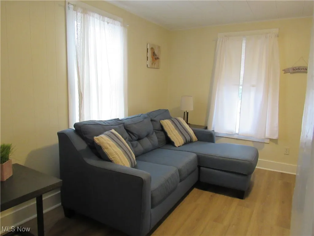Neutral living room with window treatments & newer LTV flooring!