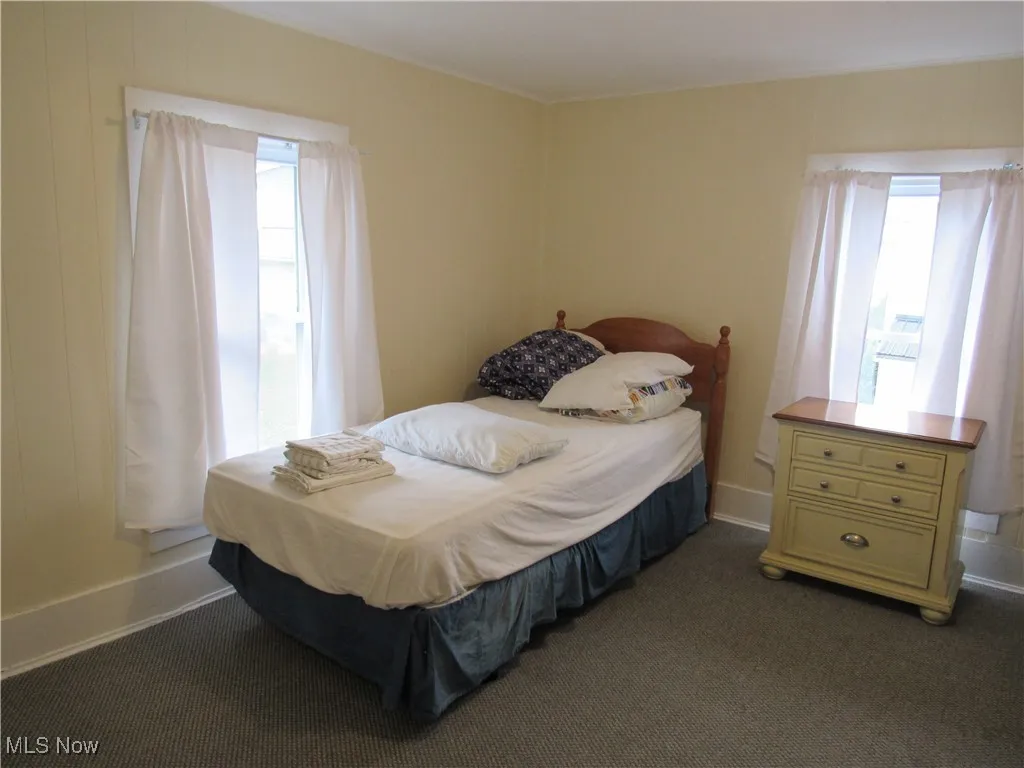First upstairs neutral bedroom with walk-in closet & window treatments!
