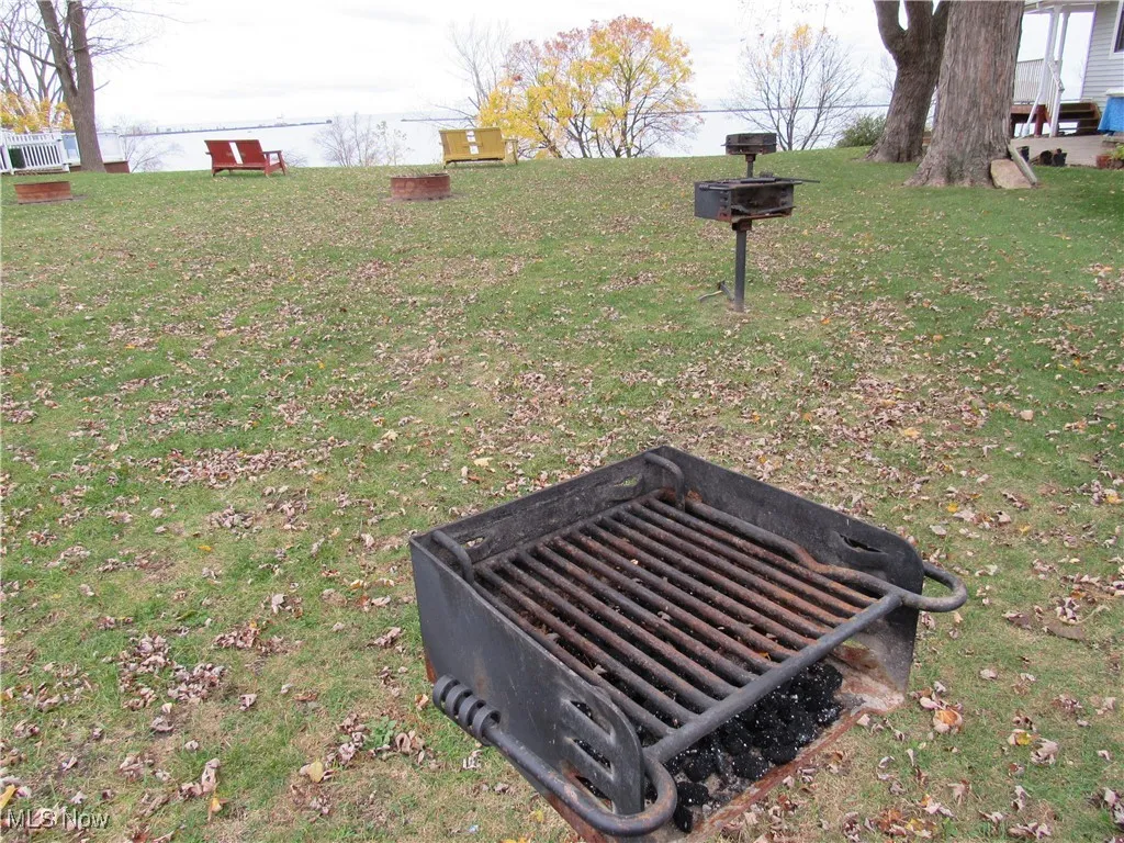View of the common area with picnic tables, grills, firepits & cozy chairs to welcome the Lake Erie views!