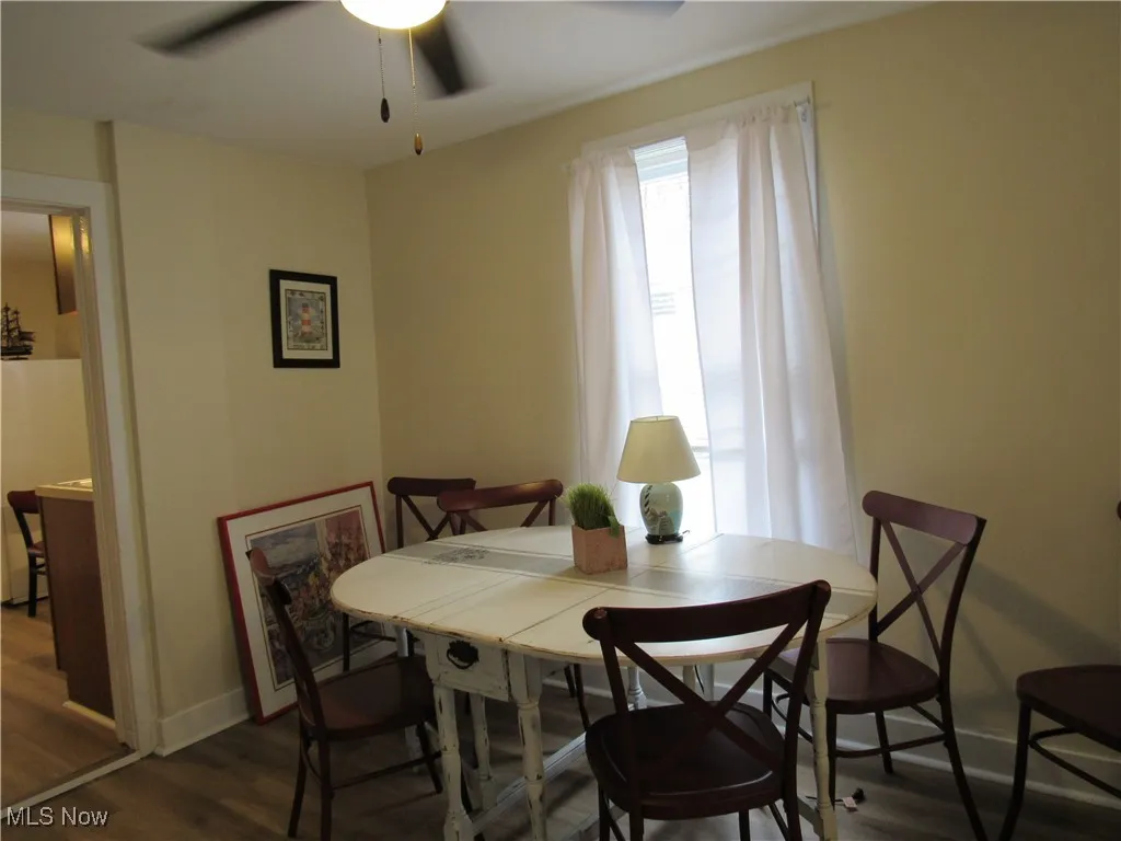 Neutral dining room featuring ceiling fan and newer LTV flooring!