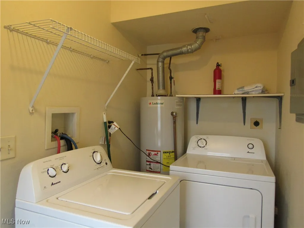 First floor laundry room with washer, dryer, updated electric panel, hot water tank & shelves!