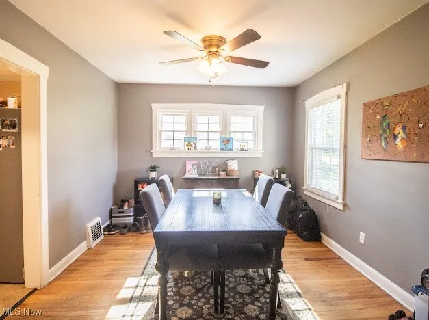 Dining space featuring a ceiling fan, plenty of natural light, and light wood-style flooring