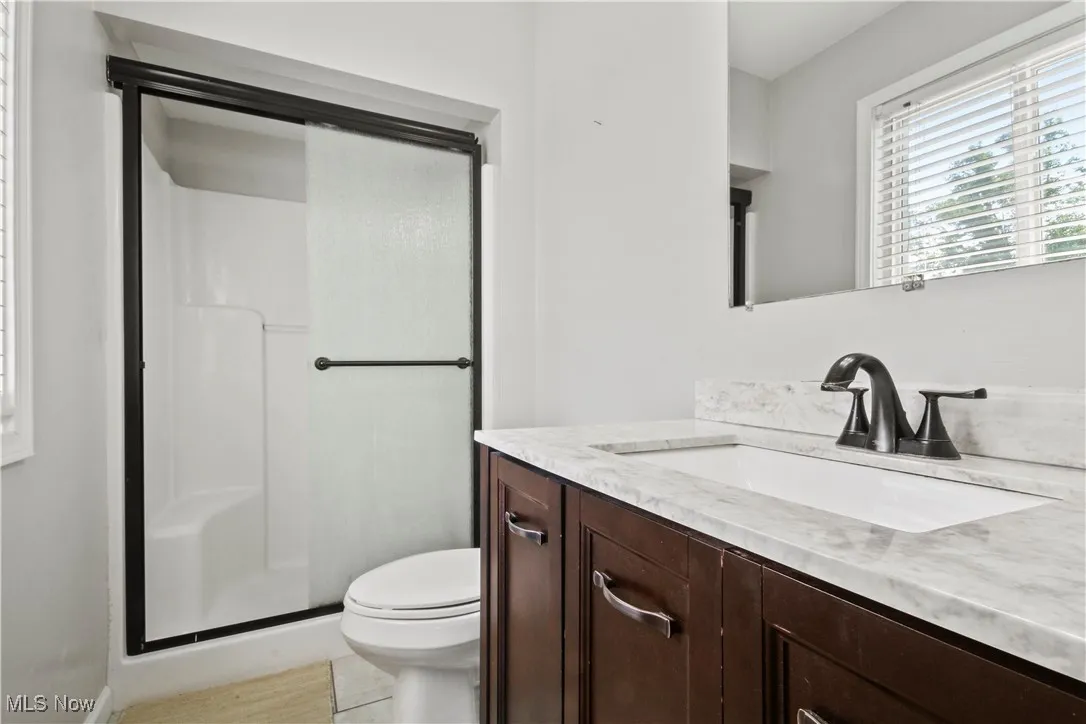 Bathroom with vanity and a stall shower