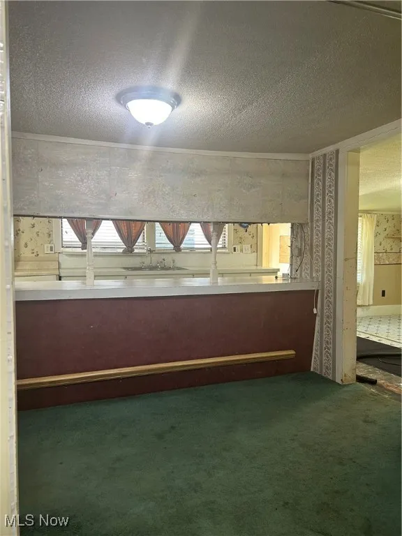 Dining area looking into kitchen, with bonus room to the right