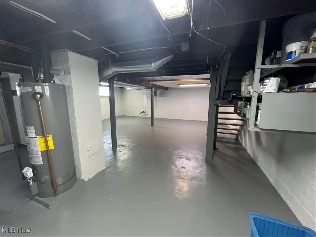 Basement with water heater and stairway