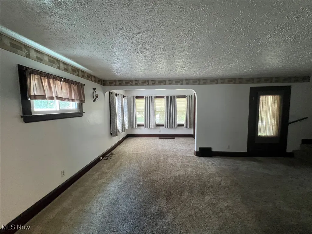 Coced area off LR featuring a textured ceiling and carpet