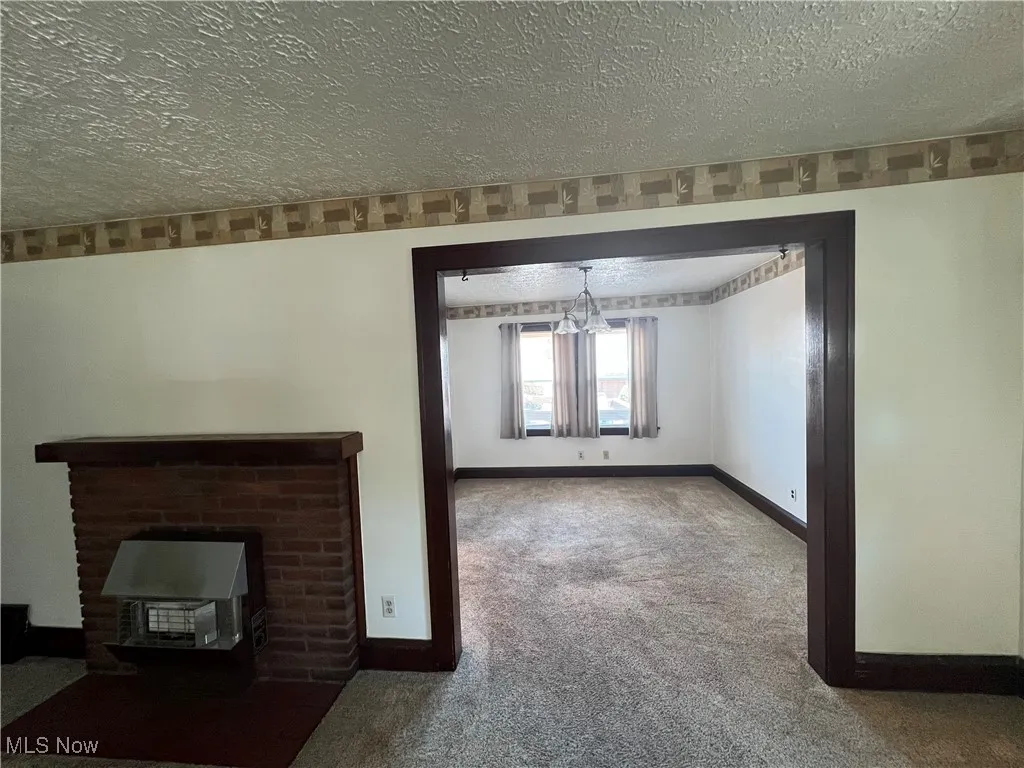 LR with  gads fp, a textured ceiling, carpet
