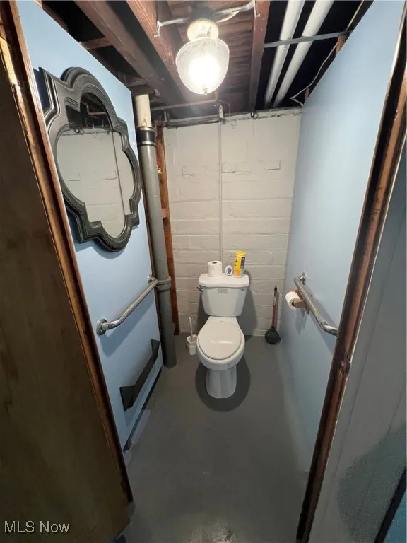 Basement BA featuring concrete floors and toilet