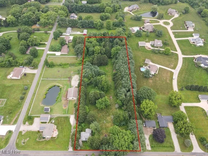 Aerial view of property and surrounding area with property parcel outlined